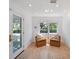 Welcoming entryway featuring wood floors, a window with natural light, and a cozy seating area at 1932 Temple Dr, Winter Park, FL 32789