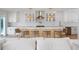 Bright kitchen boasts a large island with marble countertop and seating under stylish pendant lights at 1932 Temple Dr, Winter Park, FL 32789