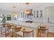 Beautiful kitchen with a large island, modern pendant lights, and white cabinets with glass doors at 1932 Temple Dr, Winter Park, FL 32789