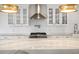 Close-up of the modern kitchen with a stainless steel range hood and elegant countertops at 1932 Temple Dr, Winter Park, FL 32789