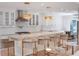 Bright kitchen boasts a large island with marble countertop and seating under stylish pendant lights at 1932 Temple Dr, Winter Park, FL 32789