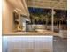 Outdoor bar area with modern barstools, stylish lighting, and a sleek countertop at 1932 Temple Dr, Winter Park, FL 32789