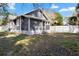 View of home from backyard with fence, showcasing yard and building architecture at 202 Division, Deland, FL 32720