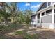 View of the home's backyard featuring mature trees and partial fence at 202 Division, Deland, FL 32720