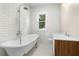 Elegant bathroom featuring a clawfoot tub, subway tile, and modern fixtures at 202 Division, Deland, FL 32720