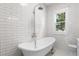 Elegant bathroom with a clawfoot tub and subway tile surround at 202 Division, Deland, FL 32720