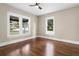 Bright bedroom featuring two windows and hardwood floors, offering ample natural light at 202 Division, Deland, FL 32720