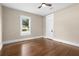 An empty bedroom showcasing hardwood floors, natural light and simple classic design at 202 Division, Deland, FL 32720