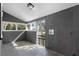 Well-lit laundry room with gray shiplap, multiple windows, and slate tile flooring at 202 Division, Deland, FL 32720