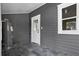 Mud room featuring slate floor and gray shiplap wall with access to the backyard at 202 Division, Deland, FL 32720