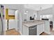 Kitchen featuring stainless steel appliances, a view to the living room, and access to the laundry room at 2207 Island Walk Dr, Orlando, FL 32824