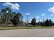 Beautiful community pond with a water fountain, surrounded by lush greenery and a blue sky at 2523 Econ Landing Blvd, Orlando, FL 32825