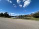 Expansive community pond view highlighting a central fountain and a bright, partly cloudy sky at 2523 Econ Landing Blvd, Orlando, FL 32825