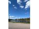 Wide angle shot of a community pond featuring a water fountain under a bright, cloudy sky at 2523 Econ Landing Blvd, Orlando, FL 32825