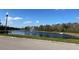 Scenic view of a community pond with a central fountain, complemented by a clear blue sky at 2523 Econ Landing Blvd, Orlando, FL 32825