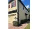 Exterior view of the home with a two-car garage and lush landscaping at 2523 Econ Landing Blvd, Orlando, FL 32825