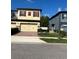 Exterior view of the home with a two-car garage and colorful shutters at 2523 Econ Landing Blvd, Orlando, FL 32825