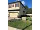 Exterior view of the home with a two-car garage and lush landscaping at 2523 Econ Landing Blvd, Orlando, FL 32825