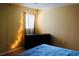 Bright bedroom featuring dresser, neutral walls, ceiling fan and a large window at 282 Scottsdale Sq # 282, Winter Park, FL 32792