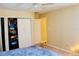 Bright bedroom featuring closet, neutral walls, ceiling fan and a large window at 282 Scottsdale Sq # 282, Winter Park, FL 32792