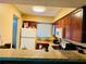 A kitchen featuring wood cabinetry, a white refrigerator, and a breakfast bar at 282 Scottsdale Sq # 282, Winter Park, FL 32792