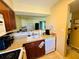 Kitchen with dark wood cabinetry, appliances, and a view of the adjacent living area at 282 Scottsdale Sq # 282, Winter Park, FL 32792