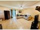 Well-lit living room with a large sectional sofa and tile flooring at 282 Scottsdale Sq # 282, Winter Park, FL 32792