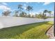 Large, grassy backyard enclosed by a white privacy fence, offering ample space and seclusion at 2857 Neverland Dr, New Smyrna Beach, FL 32168