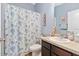 Bathroom featuring a vanity, toilet, and shower with a decorative ocean-themed shower curtain at 2857 Neverland Dr, New Smyrna Beach, FL 32168