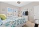 Bright bedroom featuring natural light, comfortable bed, and coastal decor at 2857 Neverland Dr, New Smyrna Beach, FL 32168