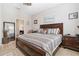 Comfortable main bedroom with wood furniture, natural light, and a view to an ensuite bathroom at 2857 Neverland Dr, New Smyrna Beach, FL 32168