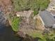 An aerial view of a single-Gathering home backing onto a tranquil pond and surrounded by lush landscaping at 302 Bridie Ct, Winter Springs, FL 32708