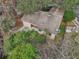 Overhead shot highlighting a house with a backyard adjacent to a pond and surrounded by mature trees at 302 Bridie Ct, Winter Springs, FL 32708