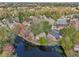 Wide aerial shot displaying the home's location on a picturesque pond within a peaceful residential area at 302 Bridie Ct, Winter Springs, FL 32708