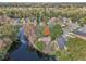 Aerial view showcasing a house located on a beautiful pond in a neighborhood. GPS pin indicates location at 302 Bridie Ct, Winter Springs, FL 32708