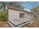 Backyard showcasing a patio with steps, a sliding glass door to the interior, and natural surroundings at 302 Bridie Ct, Winter Springs, FL 32708