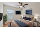 Bedroom with a ceiling fan, large window, neutral colors and decor at 302 Bridie Ct, Winter Springs, FL 32708