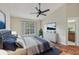 Well-lit bedroom featuring a ceiling fan and large window with serene outdoor views at 302 Bridie Ct, Winter Springs, FL 32708