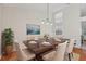 Elegant dining room featuring a decorative chandelier, a large art piece, and plenty of natural light at 302 Bridie Ct, Winter Springs, FL 32708