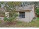 Back exterior of a house with a window and lush greenery at 302 Bridie Ct, Winter Springs, FL 32708