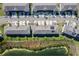 Drone eye view features community townhomes, manicured landscaping, and serene water views at 360 Arbor Lakes Dr, Davenport, FL 33896