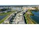 Aerial view of waterfront townhomes showcases the community with manicured landscaping and serene water views at 360 Arbor Lakes Dr, Davenport, FL 33896