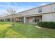 A serene backyard view with a covered patio and lush green lawn, perfect for enjoying the outdoors and entertaining guests at 360 Arbor Lakes Dr, Davenport, FL 33896