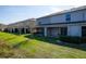 A lovely backyard featuring a well-maintained lawn and a covered patio, great for outdoor relaxation and entertaining at 360 Arbor Lakes Dr, Davenport, FL 33896