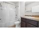 Well-lit bathroom with a shower-tub combo, neutral walls, vanity, and tile flooring at 360 Arbor Lakes Dr, Davenport, FL 33896