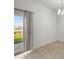 Dining room view of the lake, landscaping, and a sliding glass door at 360 Arbor Lakes Dr, Davenport, FL 33896