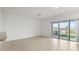 Living room with a sliding glass door and view to the lake at 360 Arbor Lakes Dr, Davenport, FL 33896