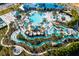 Stunning aerial view of resort-style pools, lazy river, clubhouse, and lush landscaping at 3926 Lana Ave, Davenport, FL 33897