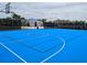 Bright blue basketball court with clear markings, ready for friendly games and recreation at 3926 Lana Ave, Davenport, FL 33897