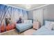 Well-coordinated ' bedroom with Frozen artwork, two twin beds, and a ceiling mounted light at 3926 Lana Ave, Davenport, FL 33897